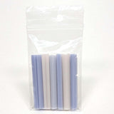 A clear plastic bag containing a set of seven cylindrical objects, which appear to be candles or similar items.