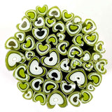 a circular arrangement of green and white heart-shaped objects, creating a visually striking and abstract composition.