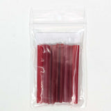 A clear plastic bag containing a group of red plastic tubes or sticks.