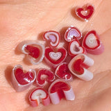 a collection of heart-shaped objects, possibly made of candy or other confections, arranged on a surface.