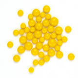 numerous small, round, yellow objects scattered across a white background.