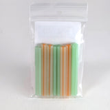 A clear plastic bag containing a collection of colorful, striped straws.