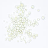 numerous small, white, spherical objects scattered across a plain white background.