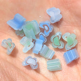 a collection of small, colorful beads or shapes scattered on a surface.