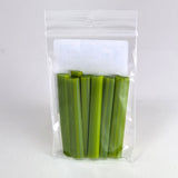 A clear plastic bag containing several green celery stalks.
