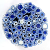 a circular arrangement of blue and white glass rods or tubes, creating a visually striking and intricate design.