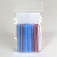A clear plastic bag containing a set of blue and red plastic straws.