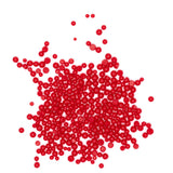 a large pile of red, round beads scattered on a white background.