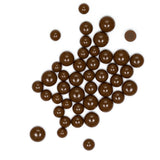 a collection of brown chocolate balls scattered on a white background.