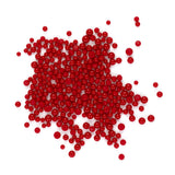 a large pile of red beads or spheres scattered on a white background.