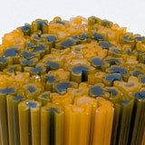 a close-up view of a collection of colorful, elongated objects resembling candles or sticks, with a mix of yellow and blue colors.