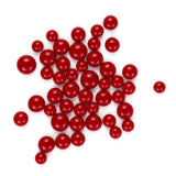 a collection of red spheres, possibly beads or candies, scattered across a white background.
