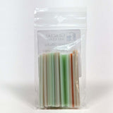 A clear plastic bag containing a collection of colorful, striped objects.