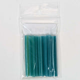 A clear plastic bag containing a set of blue and green plastic tubes.