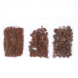 Three transparent plastic bags filled with chocolate candies are arranged in a row.