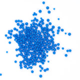 numerous small, round blue beads scattered across a white background.