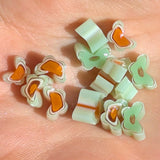 a collection of small, colorful beads or stones arranged on a surface.